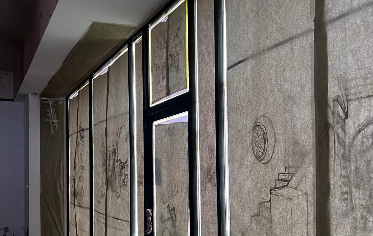 Storefront frames masked and prepared on an occupied building